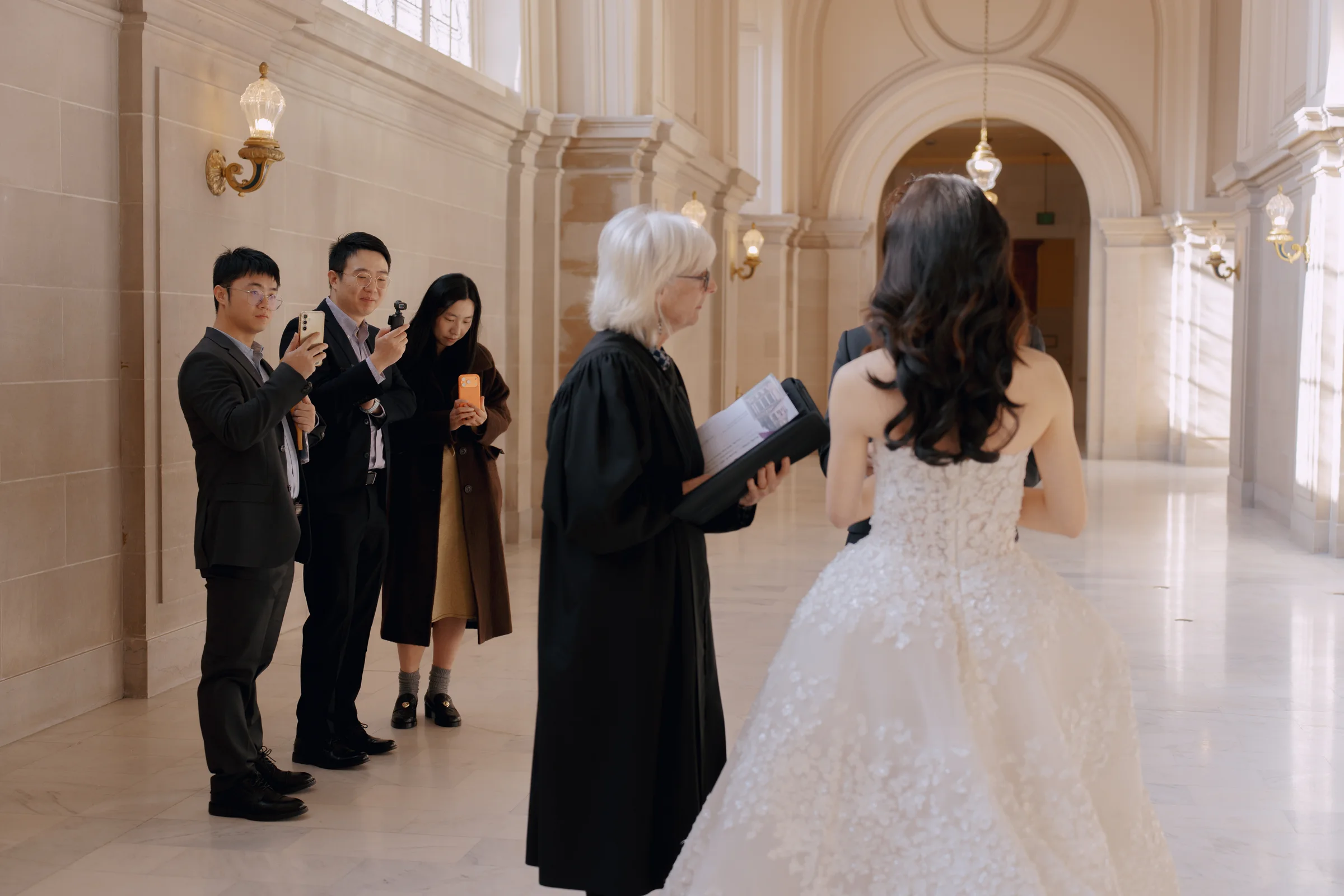 Officiant reading as the couple stands for their ceremony in the City Hall rotunda